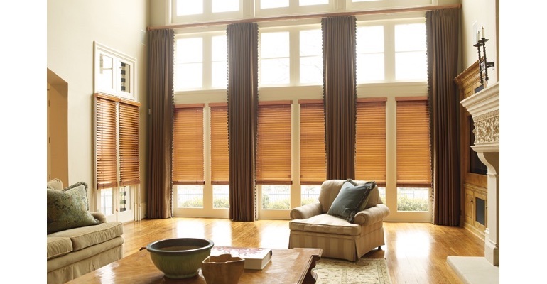 Dallas great room with wooden blinds and full-length drapes.
